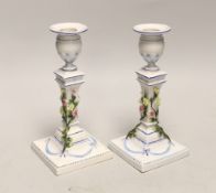 A pair of German porcelain candlesticks, marked JR, with applied floral decoration, 18cm