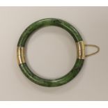 A spinach green jade bangle with metal mounts, 8.5 cm diameter (outer edge to edge)