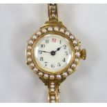 A lady's early 20th century 18ct gold and seed pearl set manual wind wrist watch, on a flexible 15ct