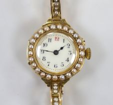 A lady's early 20th century 18ct gold and seed pearl set manual wind wrist watch, on a flexible 15ct