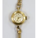 A lady's yellow metal Girard Perregaux manual wind wrist watch, on a 9ct twin strand bracelet, gross