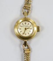 A lady's yellow metal Girard Perregaux manual wind wrist watch, on a 9ct twin strand bracelet, gross