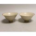 A pair of Chinese Ding type relief moulded bowls, 12cm in diameter