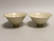 A pair of Chinese Ding type relief moulded bowls, 12cm in diameter
