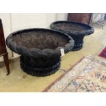 A large pair of circular weathered cast iron planters, diameter 82cm, height 43cm