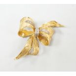 A 1970's 9ct gold and diamond chip set bow brooch, 51mm, gross weight 11.2 grams.