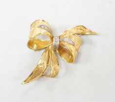 A 1970's 9ct gold and diamond chip set bow brooch, 51mm, gross weight 11.2 grams.
