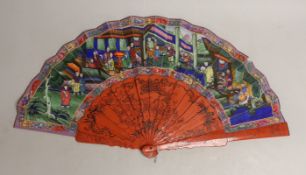 A Chinese hand painted figural fan with applied ivory faces and red lacquered guards, and boxed both