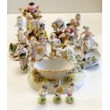 A collection of Continental porcelain figures, candleholders, table centres, some marked ‘AR’,