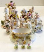 A collection of Continental porcelain figures, candleholders, table centres, some marked ‘AR’,