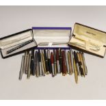 A group of fountain pens and ballpoint pens including a cased Sheaffer set