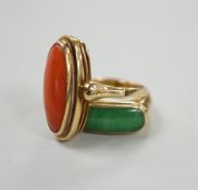 A 14ct and coral set oval ring, size O/P and a 14k and cabochon jade set ring, size P, gross