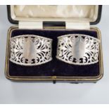 A cased pair of George V pieced silver napkin rings, Josiah Williams & Co, London, 1931.