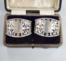 A cased pair of George V pieced silver napkin rings, Josiah Williams & Co, London, 1931.