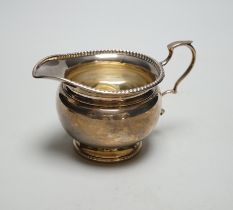 A George V silver cream jug, Harrods Ltd, Birmingham, 1931, 95 grams.