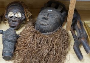 Two african tribal masks, a figure and a carved tribal head, figure 67cm long