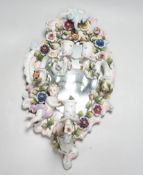 A 19th century French or German floral encrusted 3 sconce wall mirror, 48cm long