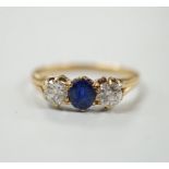 A yellow metal, single stone sapphire and two stone diamond set ring, size L, gross weight 2.3