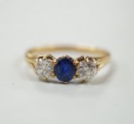 A yellow metal, single stone sapphire and two stone diamond set ring, size L, gross weight 2.3