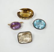 A large unmounted cut citrine, together with a mounted amethyst brooch and two other gem set