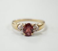 A modern 9ct gold, garnet and white sapphire? set cluster ring, size O, gross weight 2.2 grams.