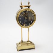 A 1920s brass gravity clock by the Watson Clock Co., stamped PAT15238/19, with vertical balance