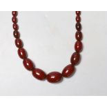 A single strand graduated cherry amber bead necklace, 82cm, 83 grams.