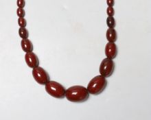 A single strand graduated cherry amber bead necklace, 82cm, 83 grams.