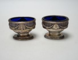 A pair of George III pierced silver oval pedestal salts, London, 1774?, length 87mm.