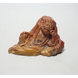 A 19th century Chinese soapstone figure of a Luohan, 12cm wide