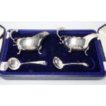 A cased pair of Edwardian silver sauceboats and pair of matching sauce ladles by Edward Barnard &