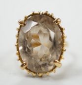 An 18ct and oval cut smoky quartz set dress ring, size G/H, gross weight 3.9 grams.