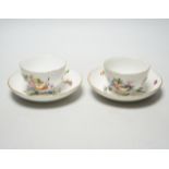 A pair of Meissen tea bowls and saucers, c.1770, hand painted with fruit, saucers 13.5cm in