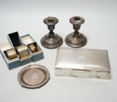 A 1960's engine turned silver mounted rectangular cigarette box, three boxed silver napkin rings,