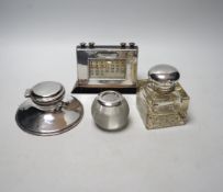 Two silver mounted inkwells, including capstan, a silver mounted desk calendar and a silver