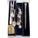 A small quantity of assorted silver or white metal spoons and other items including silver letter