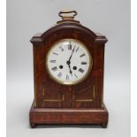 A oak mantel clock in a Regency style with pad top, striking on a coiled gong, 30cm high