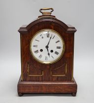 A oak mantel clock in a Regency style with pad top, striking on a coiled gong, 30cm high