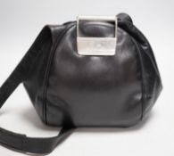 A Nina Ricci black leather shoulder bag with large metal clasp, engraved Nina Ricci, circa 1970's,
