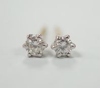 A pair of 750 and solitaire diamond set ear studs, gross weight 0.9 grams.