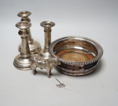 A pair of early 20th century silver mounted dwarf candlesticks, marks rubbed, height 13.2cm (a.