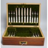 A mahogany case of plated cutlery and part set of mother of pearl handled fruit eaters, largest 46cm