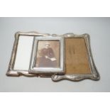 Three assorted George V silver mounted photograph frames, largest 24cm.