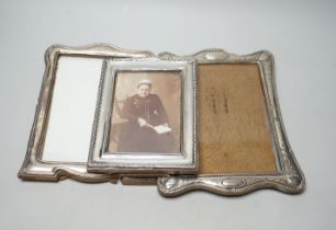 Three assorted George V silver mounted photograph frames, largest 24cm.