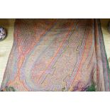 A 19th century woven multi coloured wool and silk Paisley shawl, with large all over paisley tear