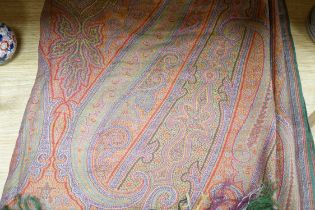 A 19th century woven multi coloured wool and silk Paisley shawl, with large all over paisley tear