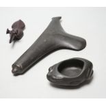 A group of black stone carvings, possibly pre-Columbian - an axe head, 24cm, a frog vessel, 10cm and