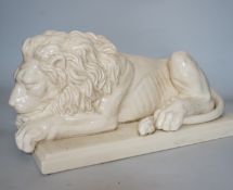 After Canova, a French cream crackleware pottery recumbent lion, 46cm wide