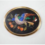 A Victorian yellow metal mounted pietra dura set oval brooch, depicting a bird and butterfly, 63mm.