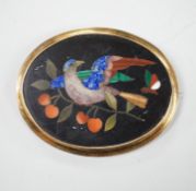 A Victorian yellow metal mounted pietra dura set oval brooch, depicting a bird and butterfly, 63mm.